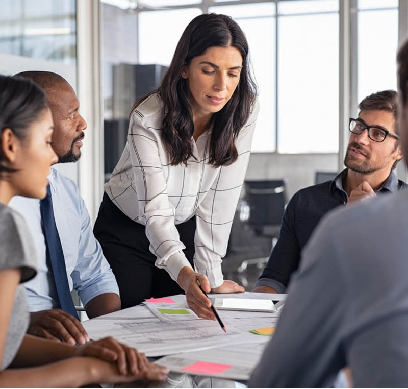 female professional round table meeting paperwork explaining